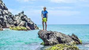 man on a rock in the ocean
