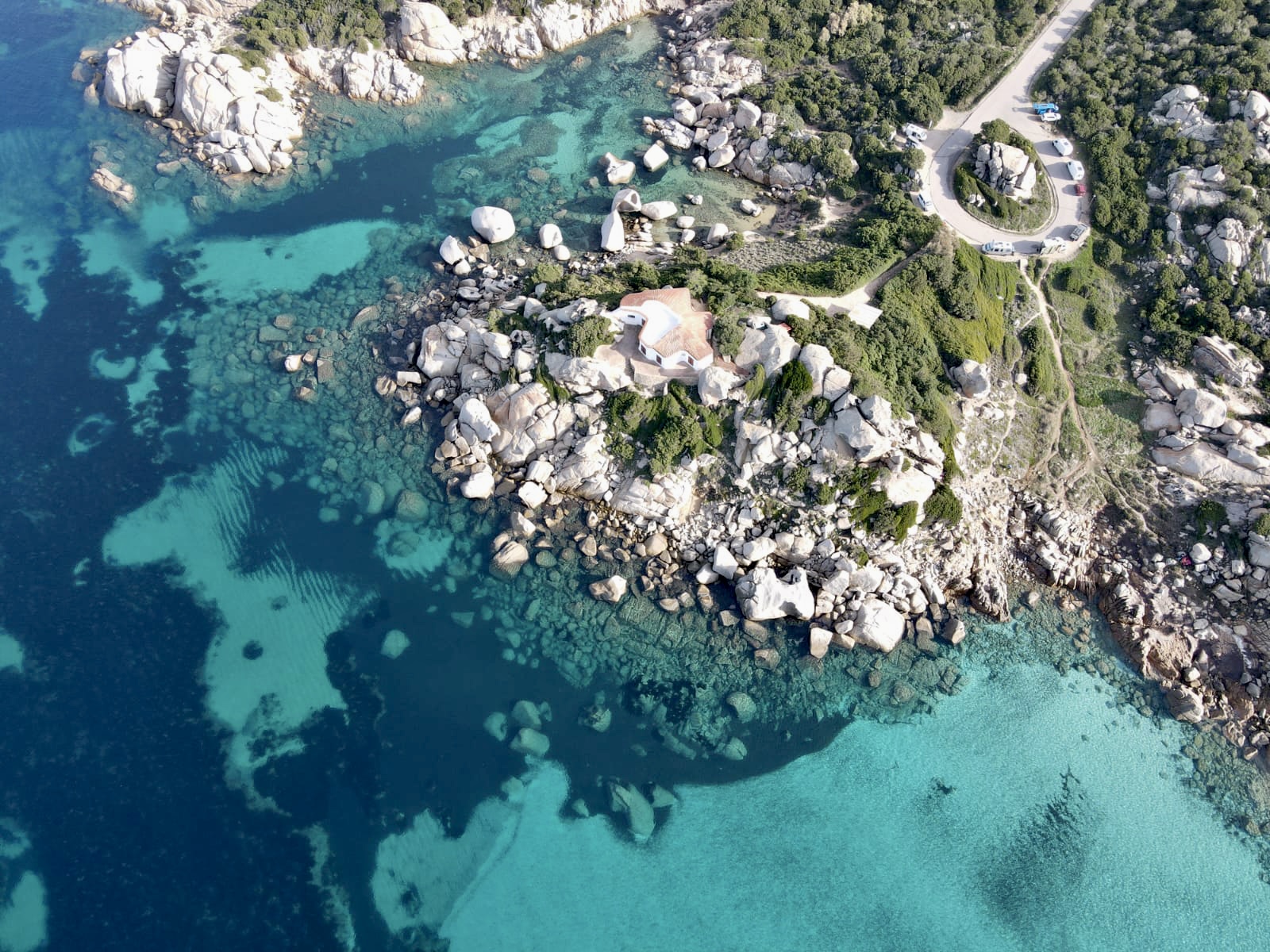 Aerial view of the coast of Sardinia Italy with clear blue and aqua green waters ad rocky landscapes