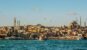 picture of the city blue sky's and water with ferry crossing the ruff water