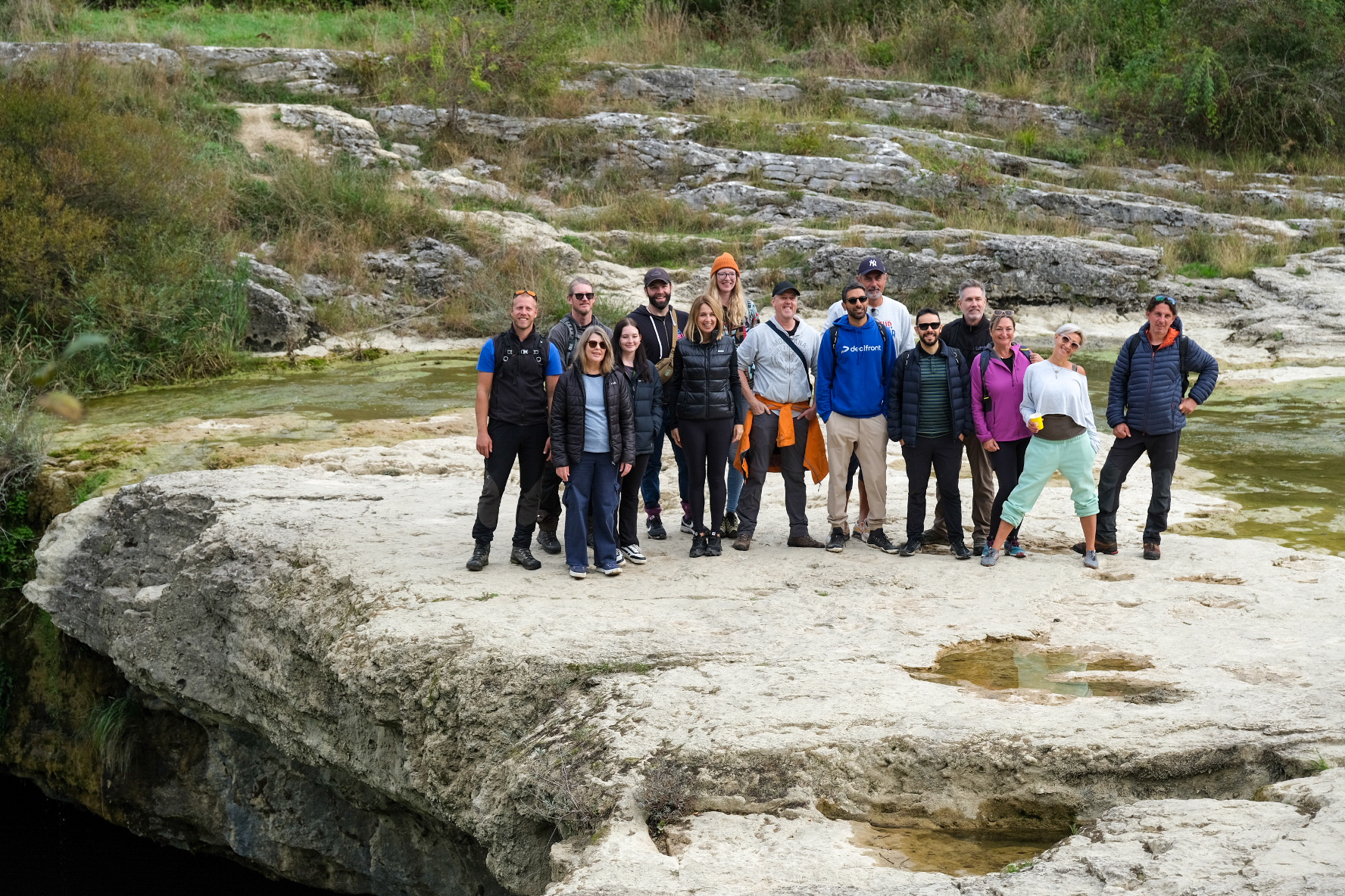 a group of people hiking to the waterfalls Croatia