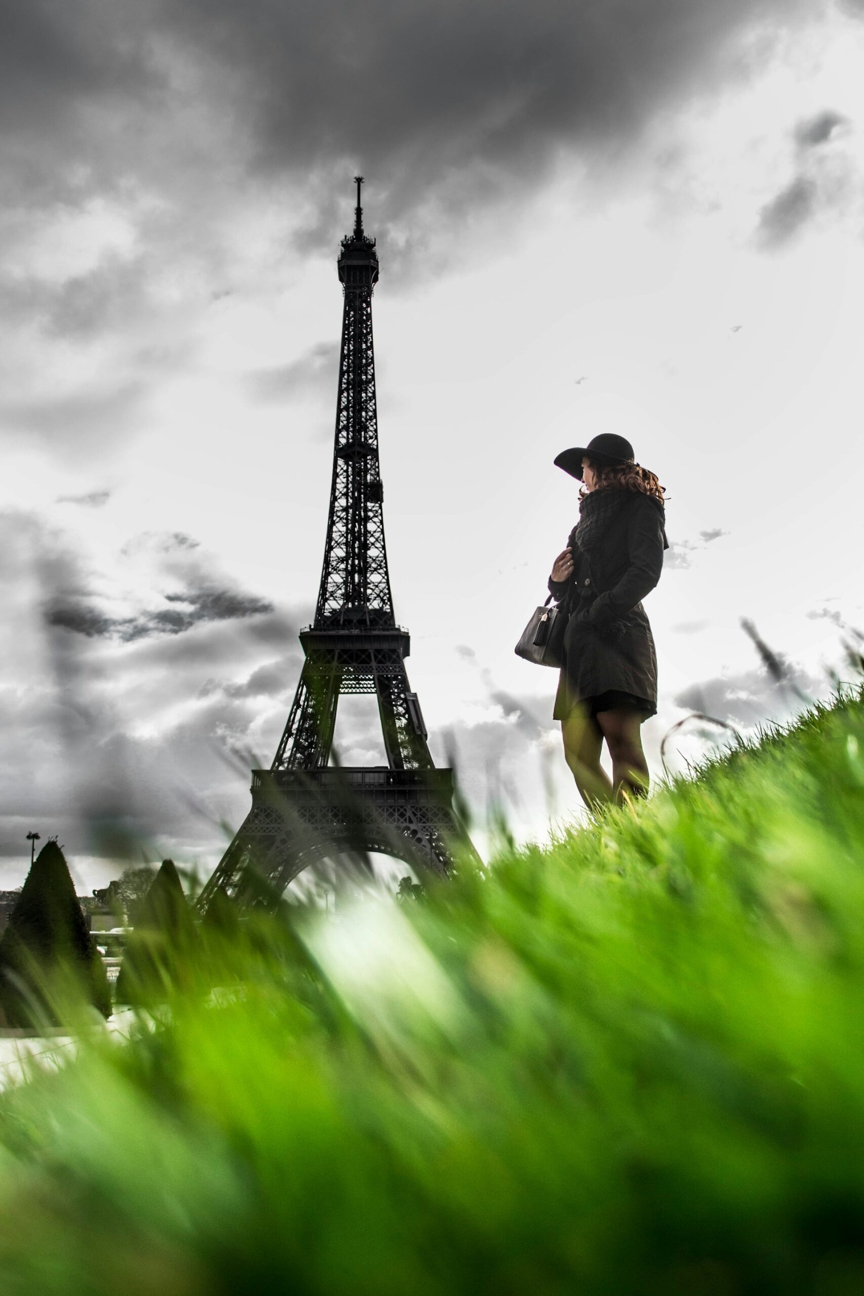 Woman traveller on a hill with the eiffel tower in Paris France in the background