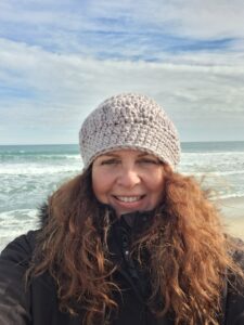 Linda A. McCall on the beach i Spain with hat hand made by Linda
