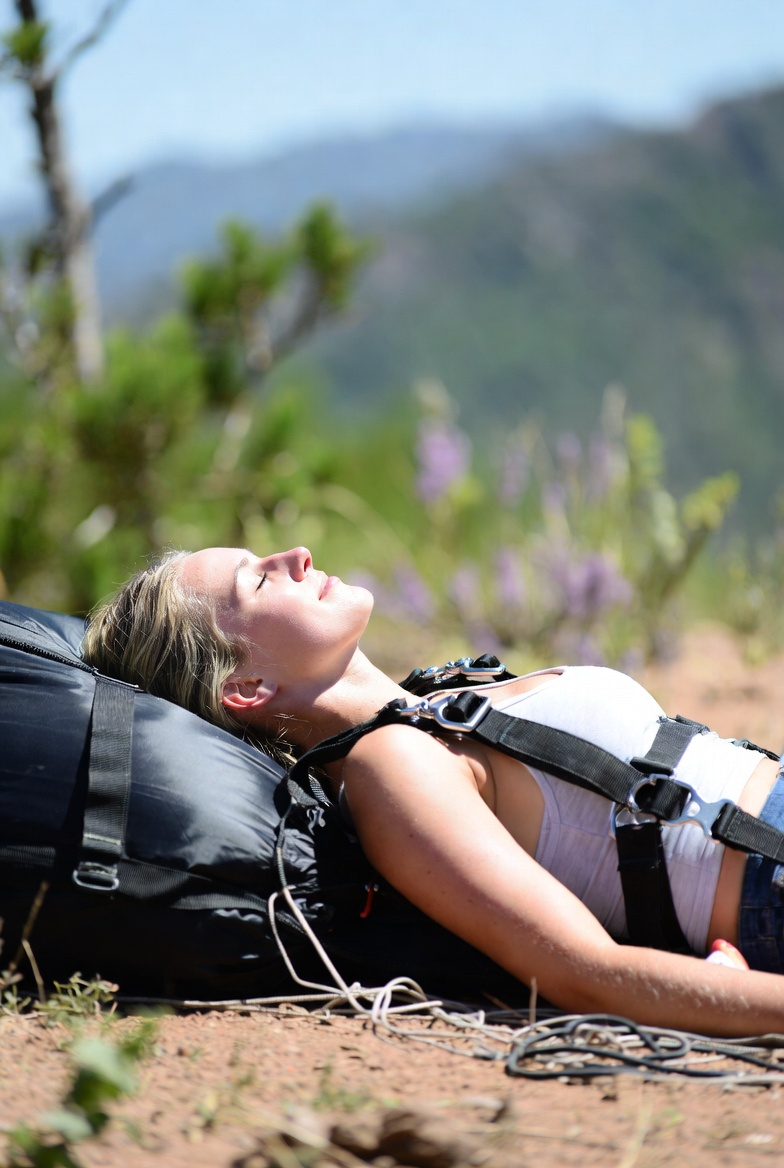 girl lying in the sun after a flight enjoying nature